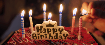 birthday cake candles being lit