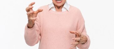 Angry mature woman on white background. Portrait of elderly senior lady grandmother feeling frustrated expressing anger, mad, upset, hostile, shouting isolated on light background.