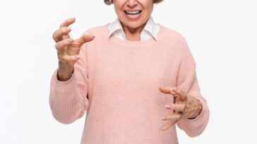 Angry mature woman on white background. Portrait of elderly senior lady grandmother feeling frustrated expressing anger, mad, upset, hostile, shouting isolated on light background.