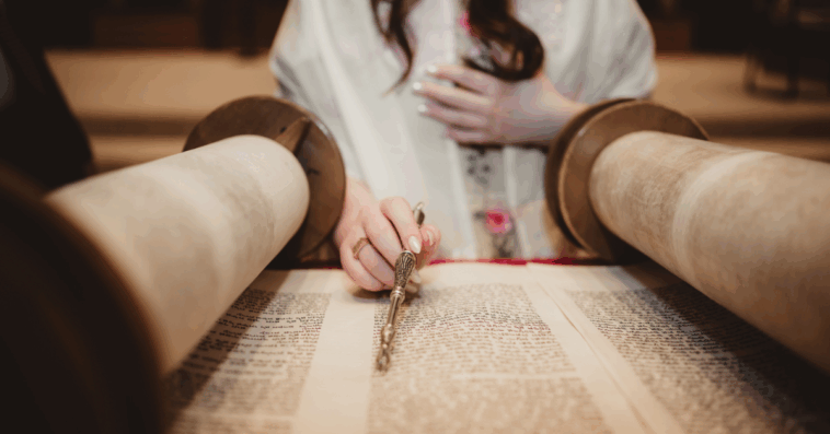A young girl reading the torah.