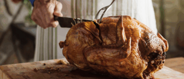 A man carving a turkey.