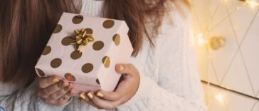 Female hands holding gift box. Christmas, New year, birthday concept.