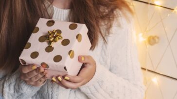 Female hands holding gift box. Christmas, New year, birthday concept.