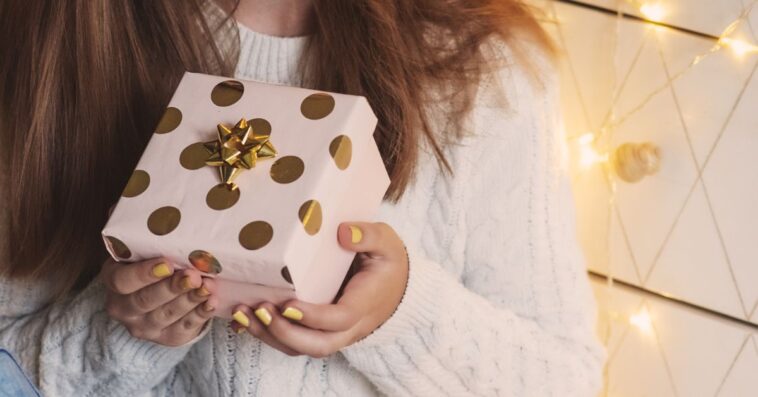 Female hands holding gift box. Christmas, New year, birthday concept.