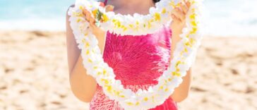 Aloha greeting with Hawaii flower lei on the beach.