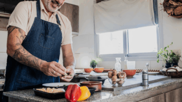 A man cooking in front of a stove.
