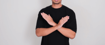 A man crossing his arms in front of his chest.