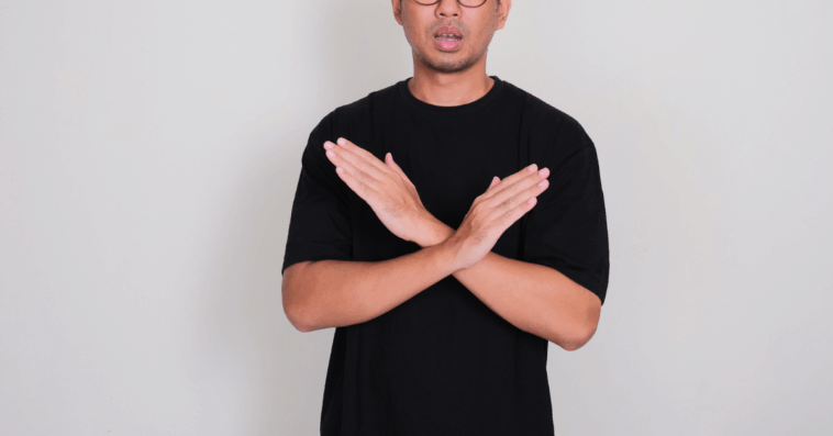 A man crossing his arms in front of his chest.