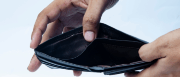 A man opening an empty wallet.