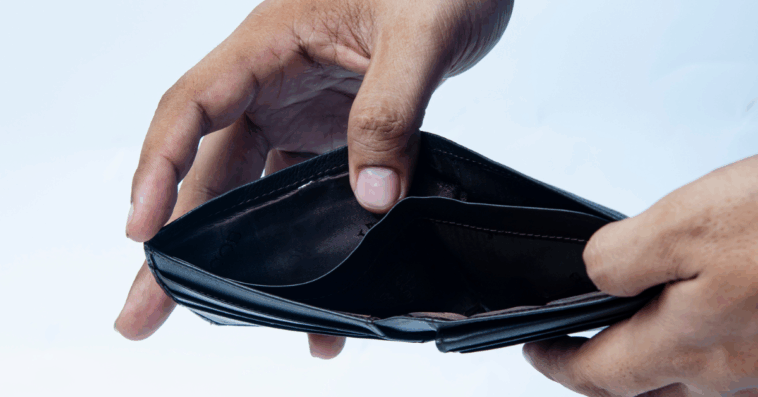 A man opening an empty wallet.