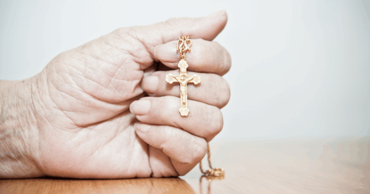 Person holding a cross