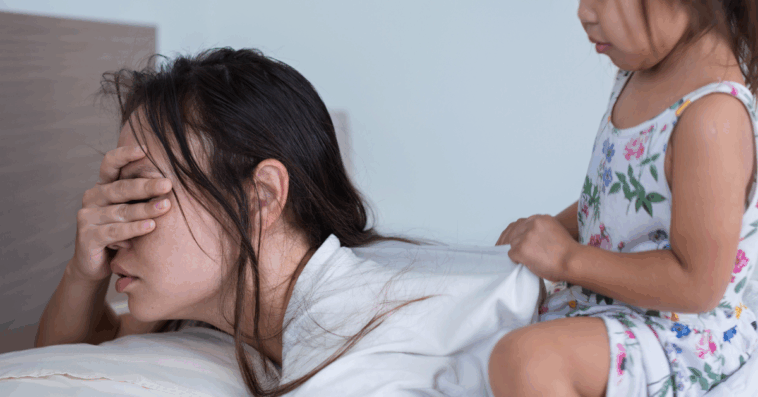 woman in bed ignoring child on her back
