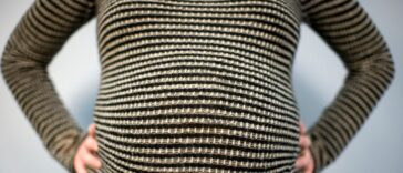 Close- up shot of a pregnant woman's stomach.