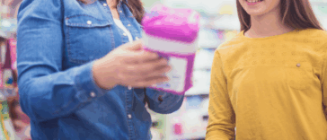 A woman showing a young woman period products