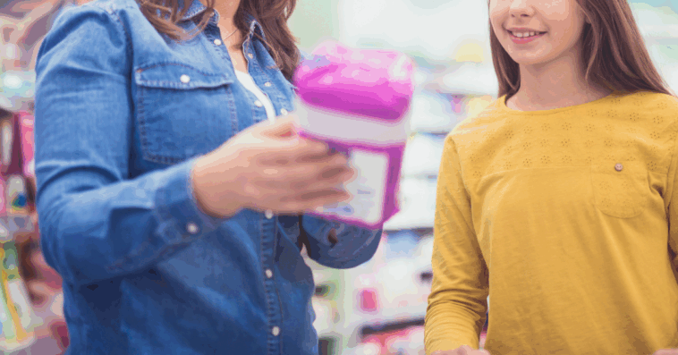 A woman showing a young woman period products