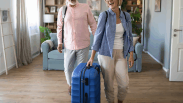 A couple entering a home with luggage