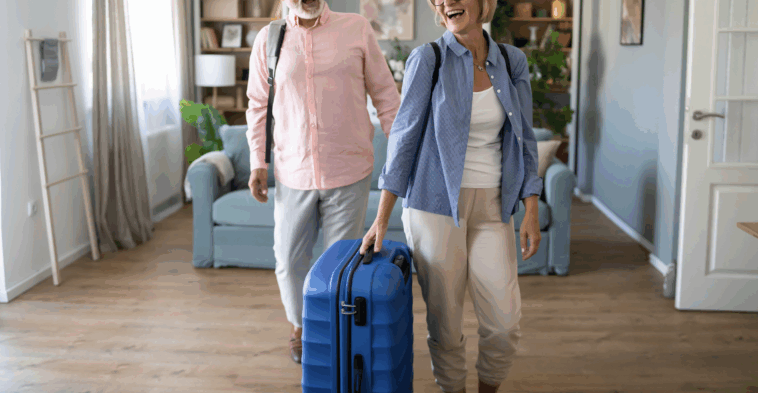 A couple entering a home with luggage