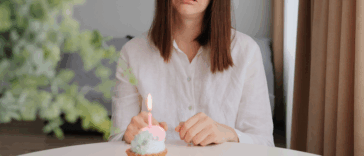sad woman with birthday cupcake