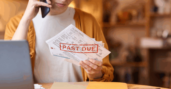 Woman frustrated while looking at past due bills