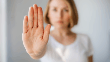 woman with hand up in front of her to indicate "no"