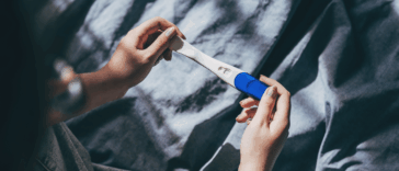 person looking at pregnancy test