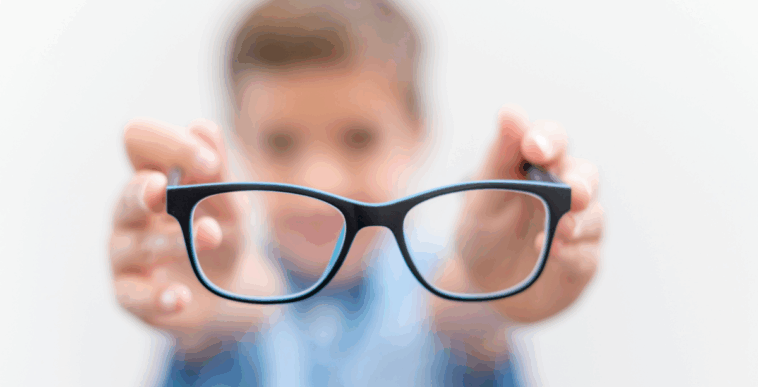 boy holding eyeglasses