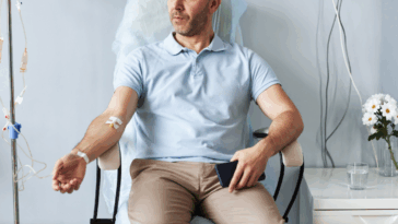 man receiving IV in hospital