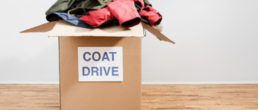 A box full of coats with a coat drive label on it
