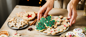 A plate of Christmas cookies on a table.