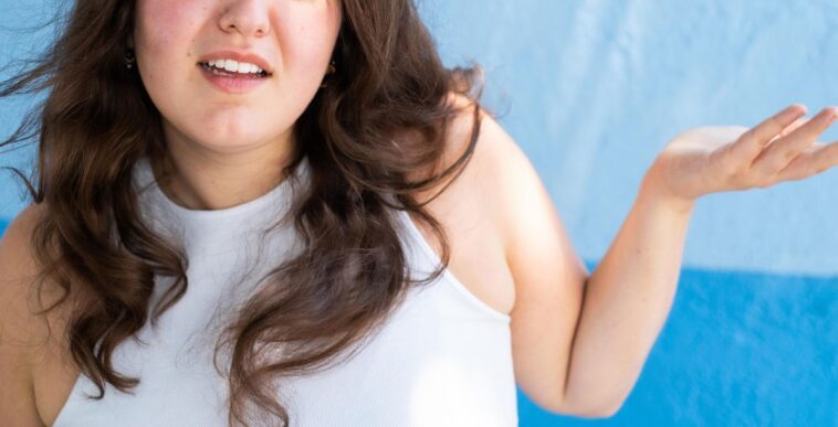Close-up of a young woman making a face looking uncertain, confused, perplexed, WTF.
