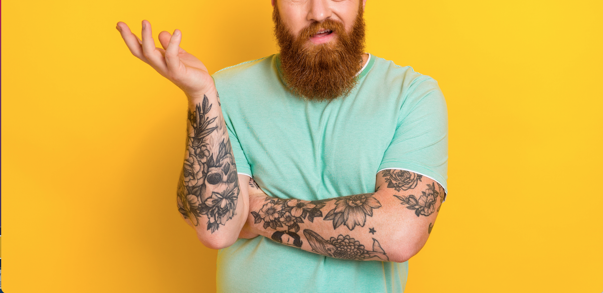 A man with tattoos on his arms.