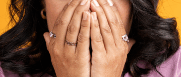 A woman covering her mouth.