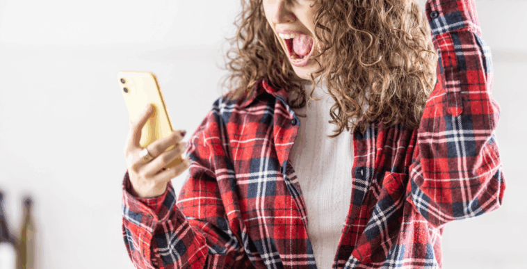 A woman screaming into her cell phone.