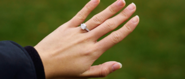 person showing off diamond engagement ring