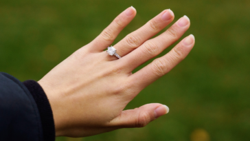 person showing off diamond engagement ring