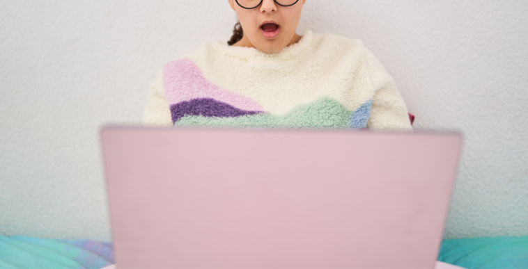 shocked woman looking at laptop screen