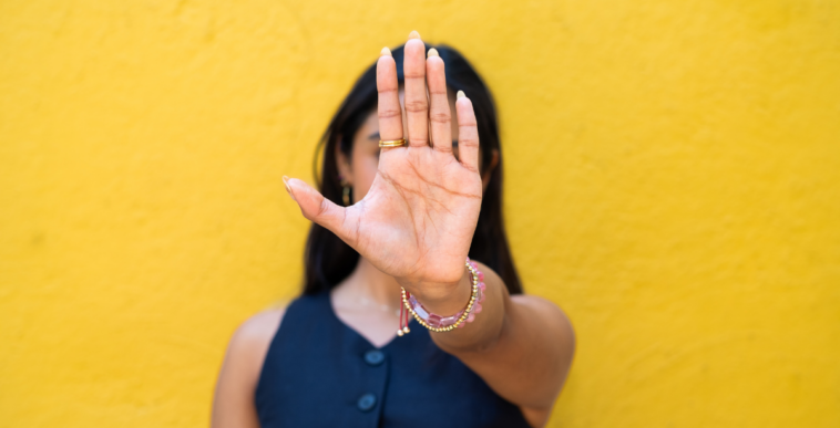 young women motioning someone to stop