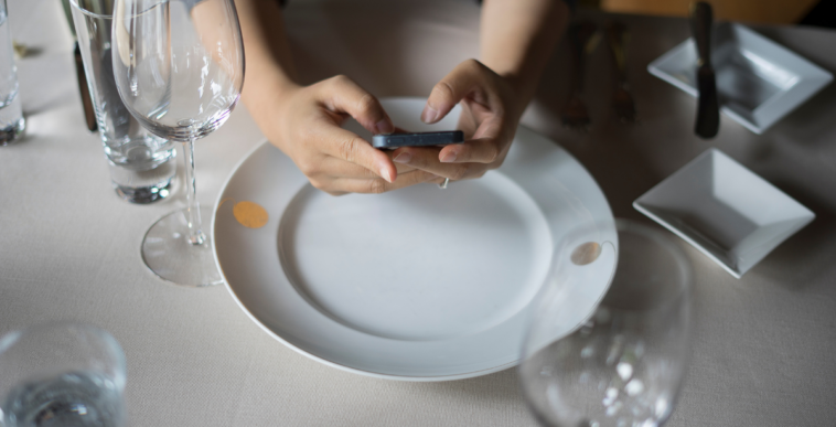 woman using cellphone in restaurant