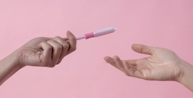 person handing tampon to another person