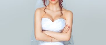 Grumpy bride. Sad and disappointed hesitating woman in wedding dress, arms folded, unhappy wife.