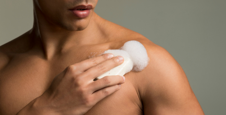 Man using soap in the shower