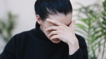 Frustrated woman with her hand covering her face