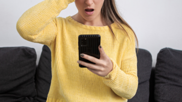 Woman shocked while looking at her phone