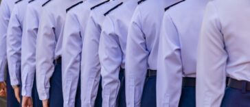 Female soldiers in light blue uniforms stand in line.