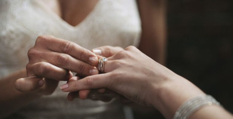Cropped shot of two unrecognisable women exchanging rings on their wedding day.