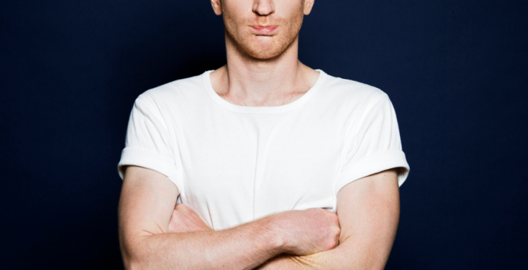 Disgruntled man with arms crossed