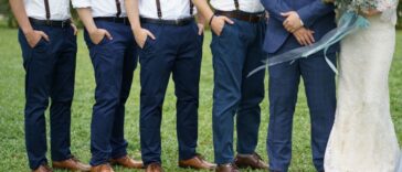 Unidentifiable groomsman pose beside a couple. The groomsmen are all wearing matching attire. Garden wedding. Concept wedding photo session.