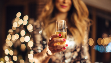 A woman holding a glass of champagne.