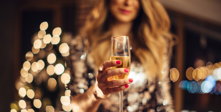 A woman holding a glass of champagne.