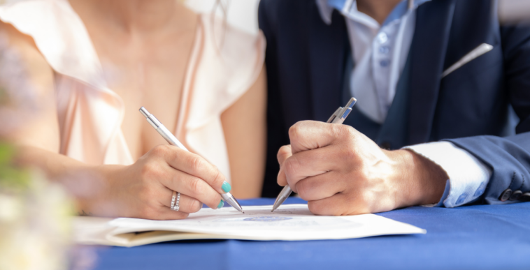 couple signing document together